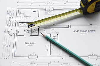 Architectural floor plan with tape measure and pencil