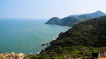 Scenic coastal landscape with turquoise ocean and green mountains