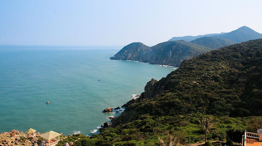 Scenic coastal landscape with turquoise ocean and green mountains