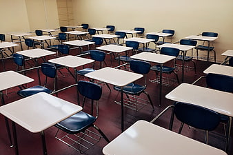 Empty Classroom with Rows of Blue Desks and Chairs