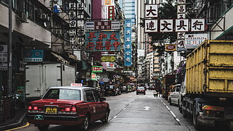 Busy Hong Kong Street Scene with Red Taxi and Chinese Signs