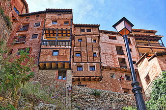 Historic Terracotta Buildings with Wooden Balconies and Street Lamp