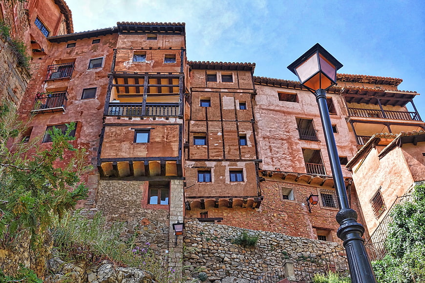 Historic Terracotta Buildings with Wooden Balconies and Street Lamp