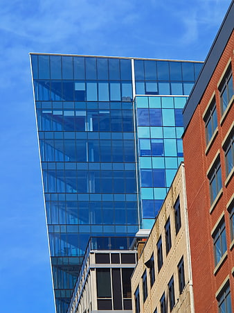 Modern Glass Skyscraper Against Blue Sky