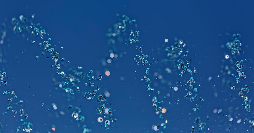 Abstract blue water bubbles rising underwater background