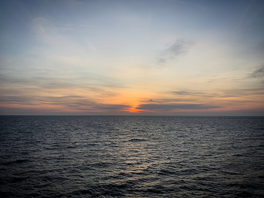 Serene Sunset Over Calm Ocean Horizon