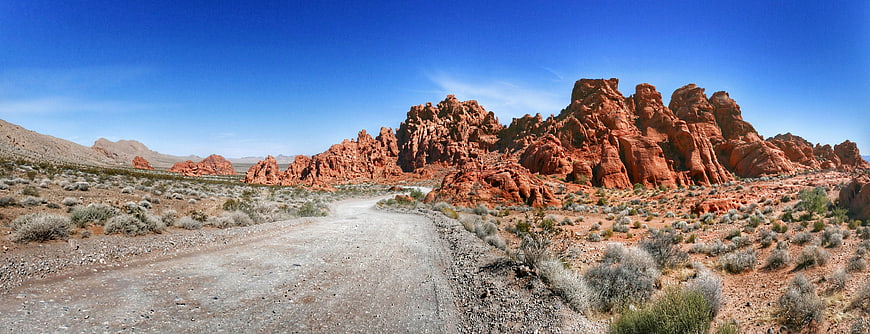 Panoramic View of Red Rock Desert Landscape with Dirt Road