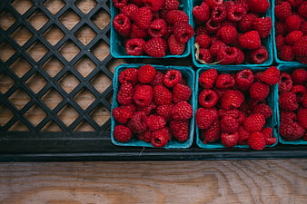 Fresh Raspberries in Blue Containers on Wooden Table