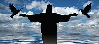 Silhouette of Christ statue with doves over ocean and clouds
