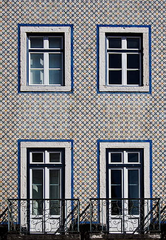 Symmetrical facade with traditional Portuguese azulejo tiles and windows