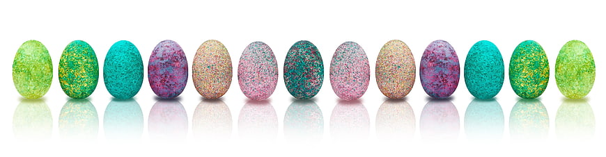 Colorful Glitter Easter Eggs in a Row on White Background