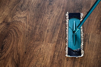 Top-Down View of Teal Mop Cleaning Dark Wooden Floor