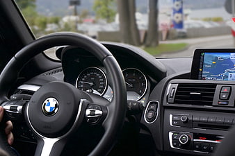 BMW car interior dashboard and steering wheel with GPS navigation