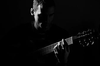 Moody Black and White Man Playing Acoustic Guitar