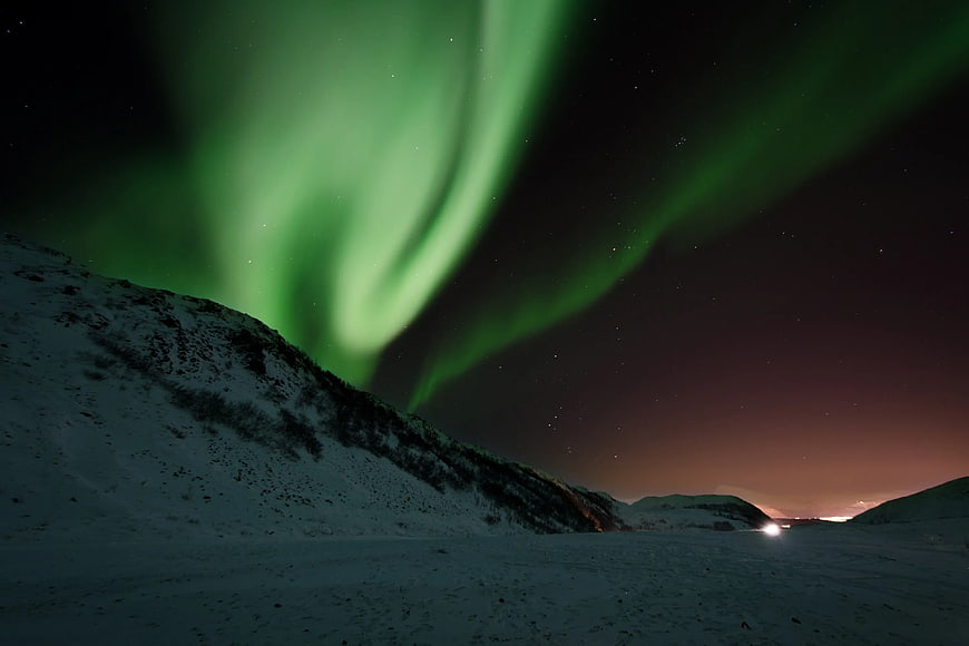 Vibrant Green Aurora Borealis Over Snowy Winter Landscape