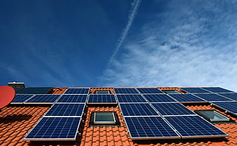 Solar Panels on Red Roof Against Blue Sky