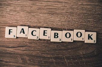 Scrabble tiles spelling Facebook on rustic wooden table