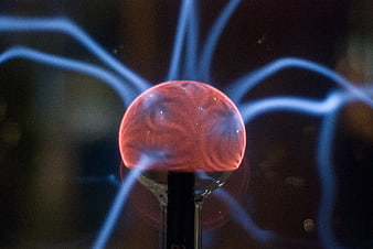 Close-up of glowing plasma ball with electric arcs