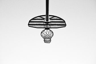 Black and white basketball hoop against white sky