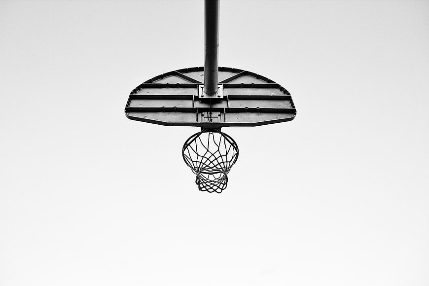Black and white basketball hoop against white sky