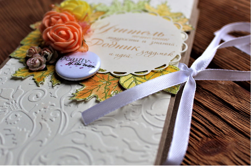 Handmade autumn greeting card with paper flowers and ribbon