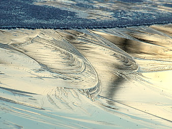 Abstract Ice Patterns on Frozen Lake Surface