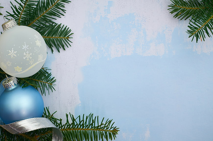 Christmas ornaments and pine branches on blue background