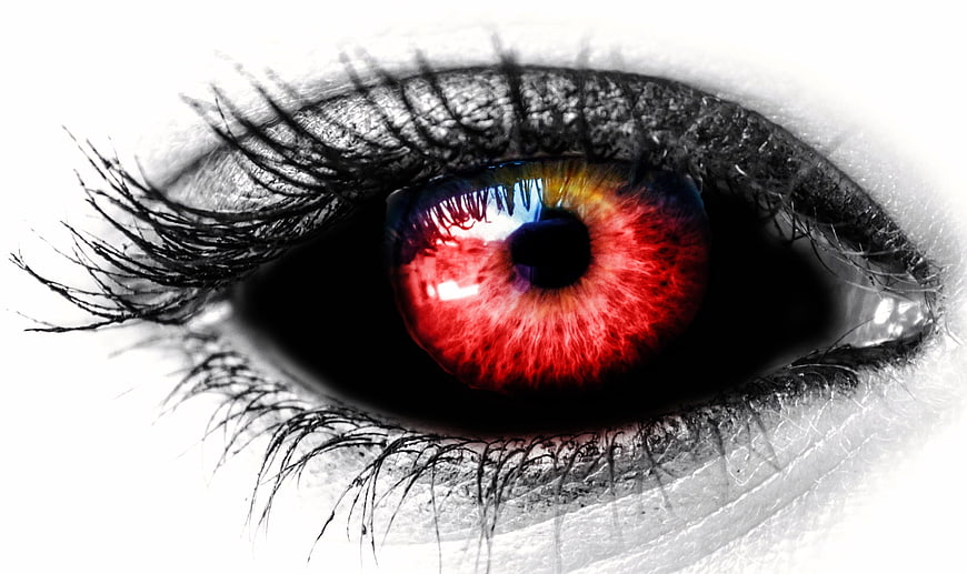 Close-up of eye with red iris and black and white makeup