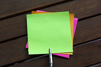 Colorful blank sticky notes clipped on wooden table