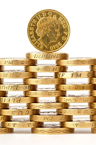 Gold coins stacked in a grid with a single coin balanced on top