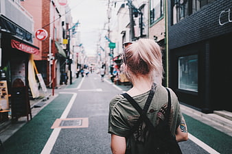 Blonde Woman Walking Down Narrow Japanese Street