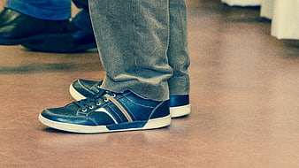 Blue Leather Sneakers with White Soles on Wooden Floor