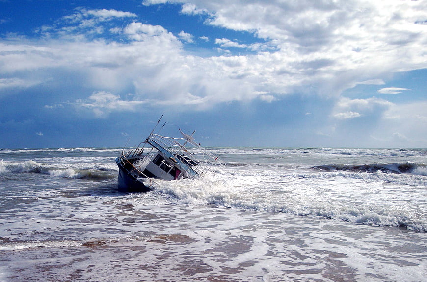 Wrecked Fishing Boat Washed Ashore on Stormy Beach