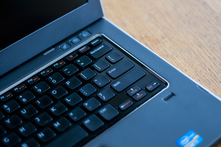 Close-up of laptop keyboard on wooden desk