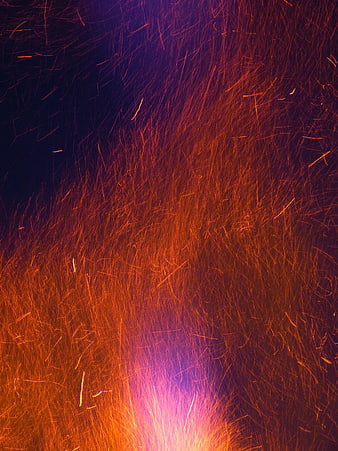 Abstract Fire Sparks Flying Upward Against Dark Background