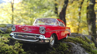 Red Vintage Toy Car on Mossy Forest Floor
