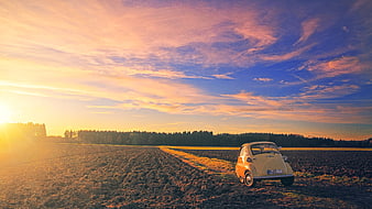 Vintage BMW Isetta in Plowed Field at Sunset