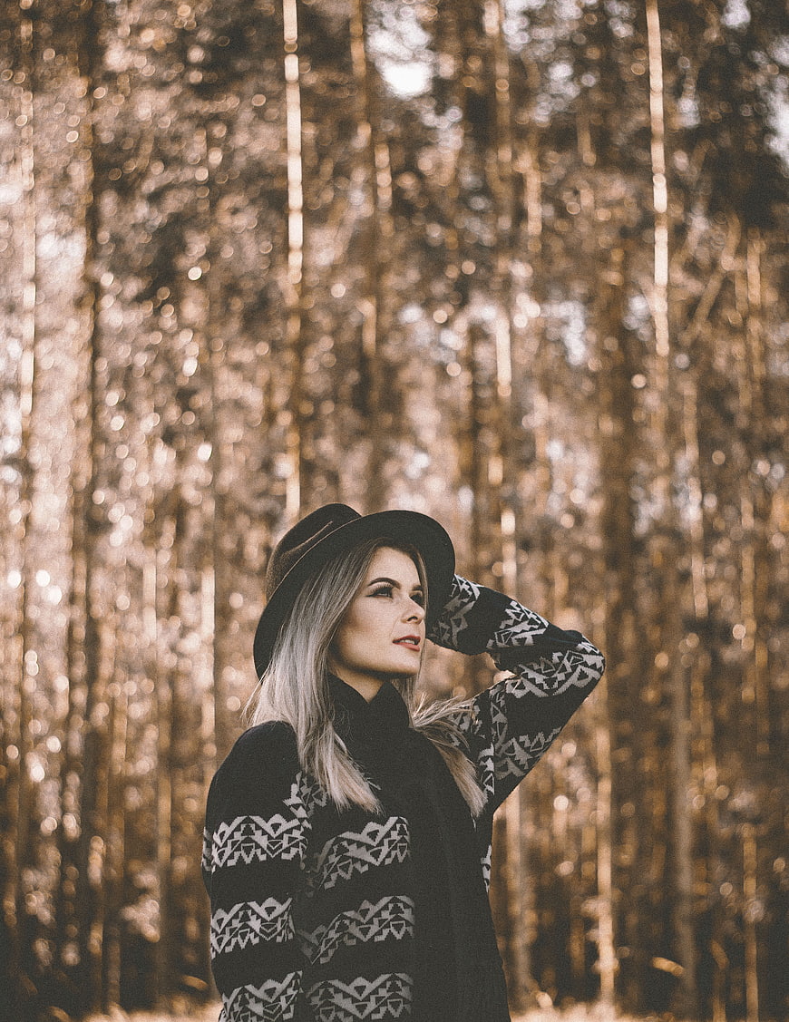Woman in Patterned Sweater and Hat in Autumn Forest