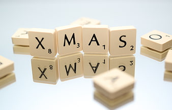 Scrabble Tiles Spelling Xmas on White Background