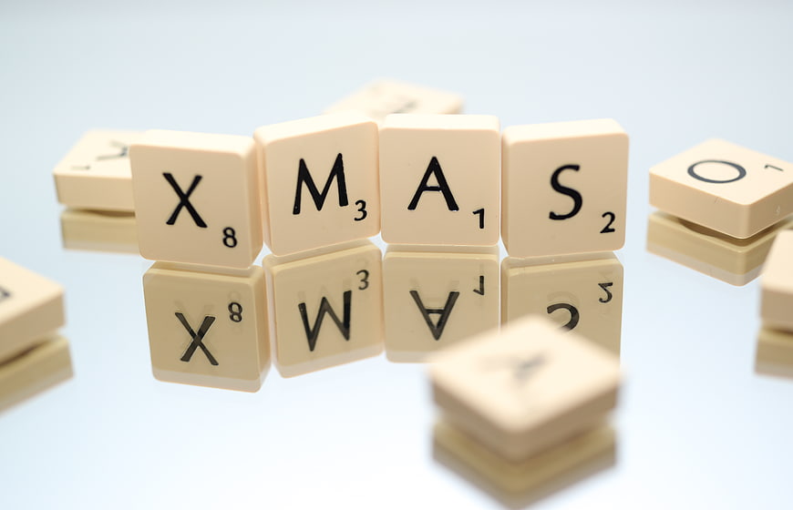 Scrabble Tiles Spelling Xmas on White Background
