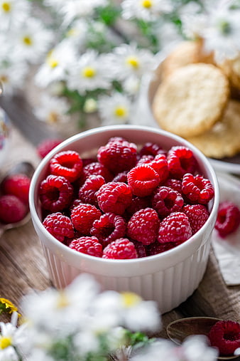 Fresh Raspberries in White Bowl with Daisies