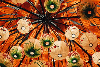 Colorful Japanese Paper Lanterns Hanging from Orange Umbrella Ceiling
