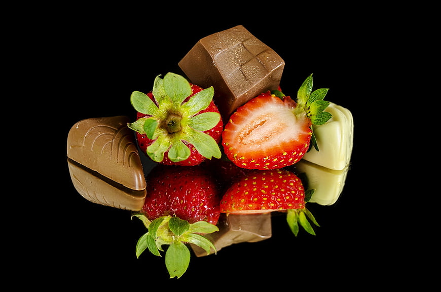 Fresh Strawberries and Chocolate on Black Reflective Surface