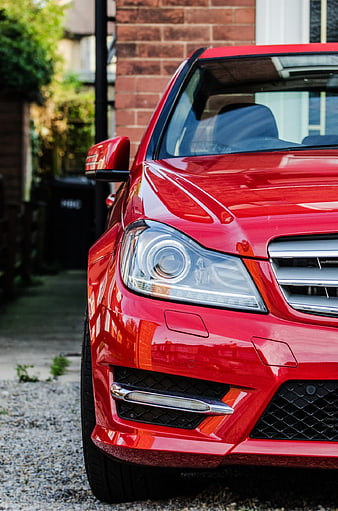 Close-up of a red car front bumper and headlight