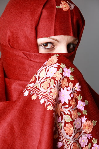 Close-up portrait of woman in red embroidered hijab