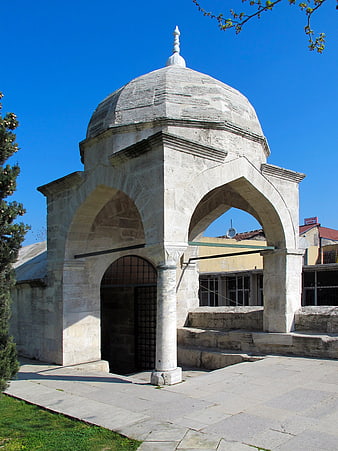 Historic Islamic stone architecture with domed roof and arched portal