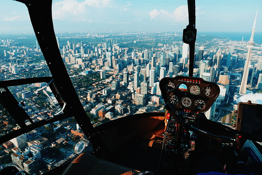 Helicopter cockpit view of Toronto skyline with CN Tower