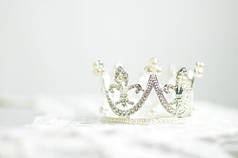 Silver tiara with pearls and crystals on white lace