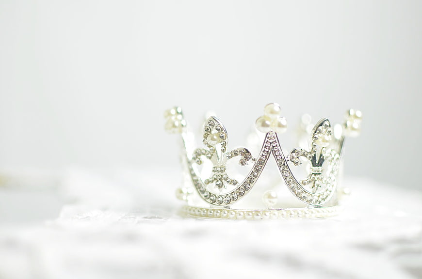 Silver tiara with pearls and crystals on white lace