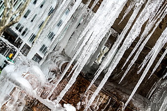 Close-up of sharp icicles hanging from a frozen fountain